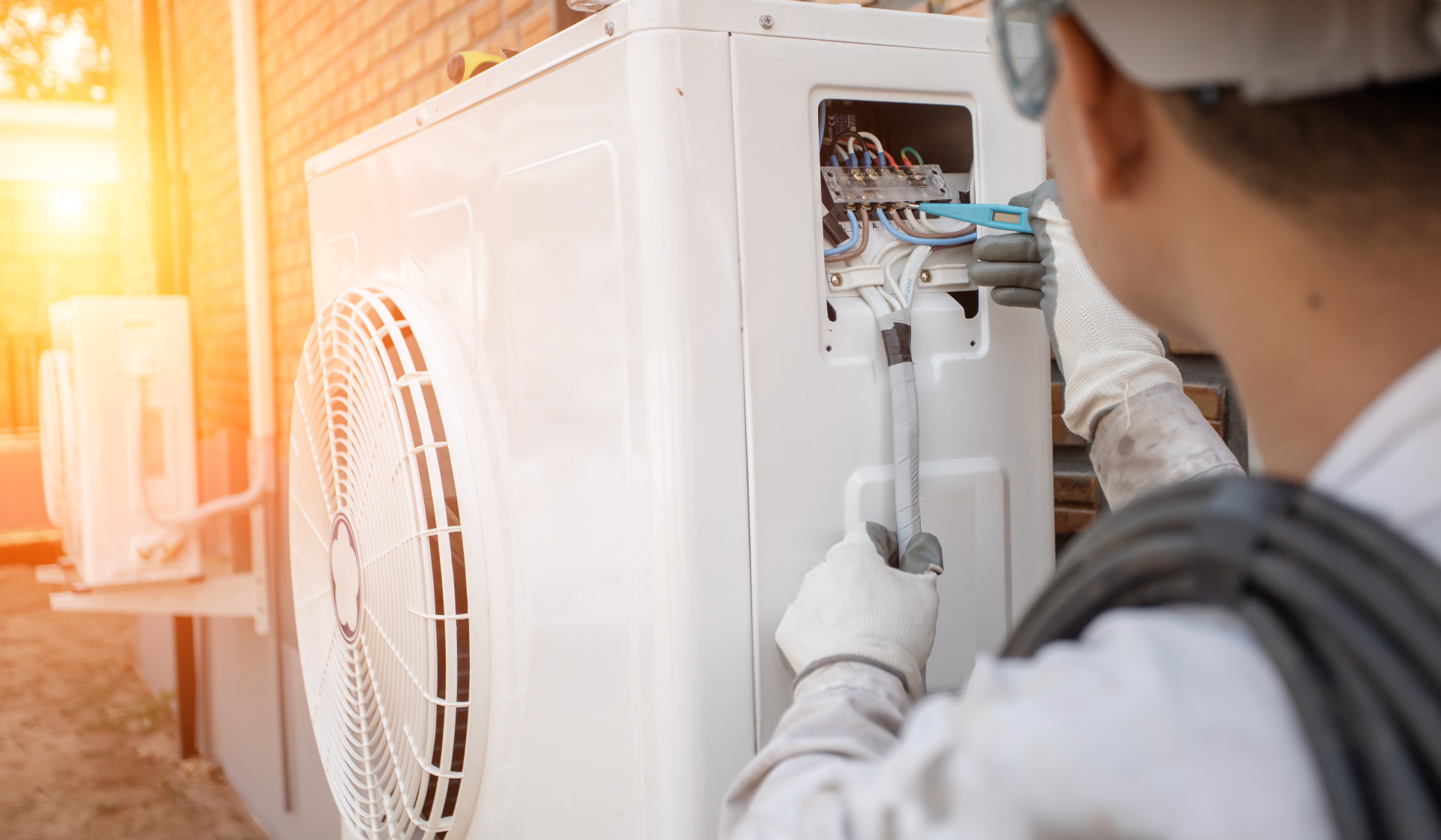 Person working on a heat pump