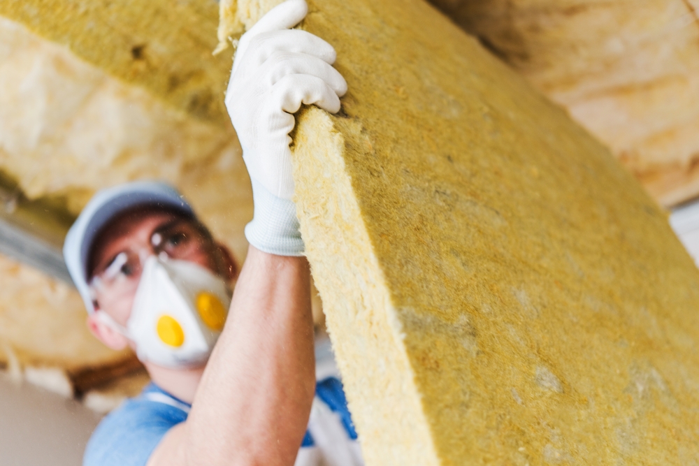 Man installing insulation. 