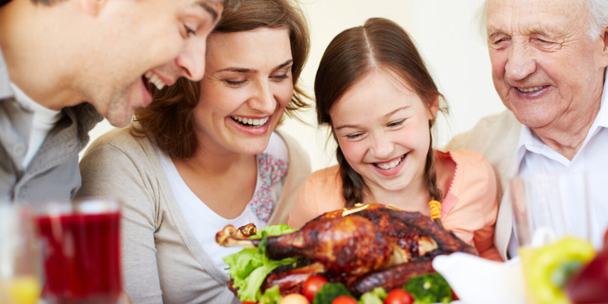 Family sharing Thanksgiving meal.