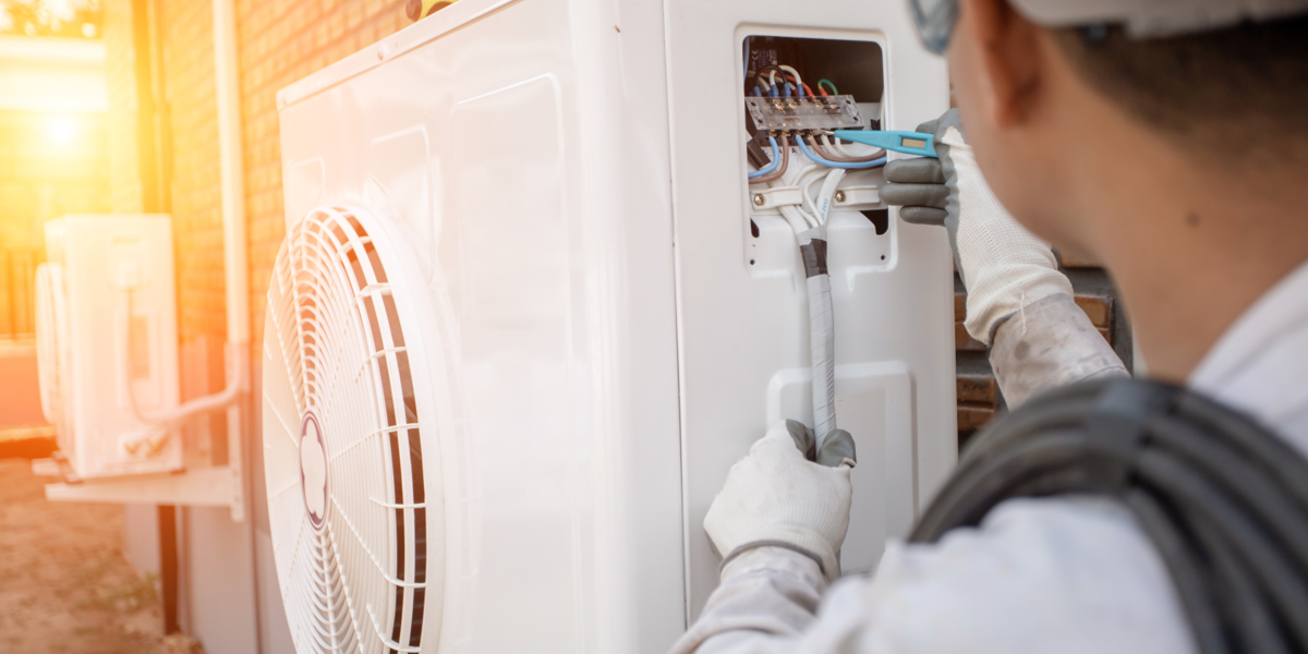 Person working on a heat pump