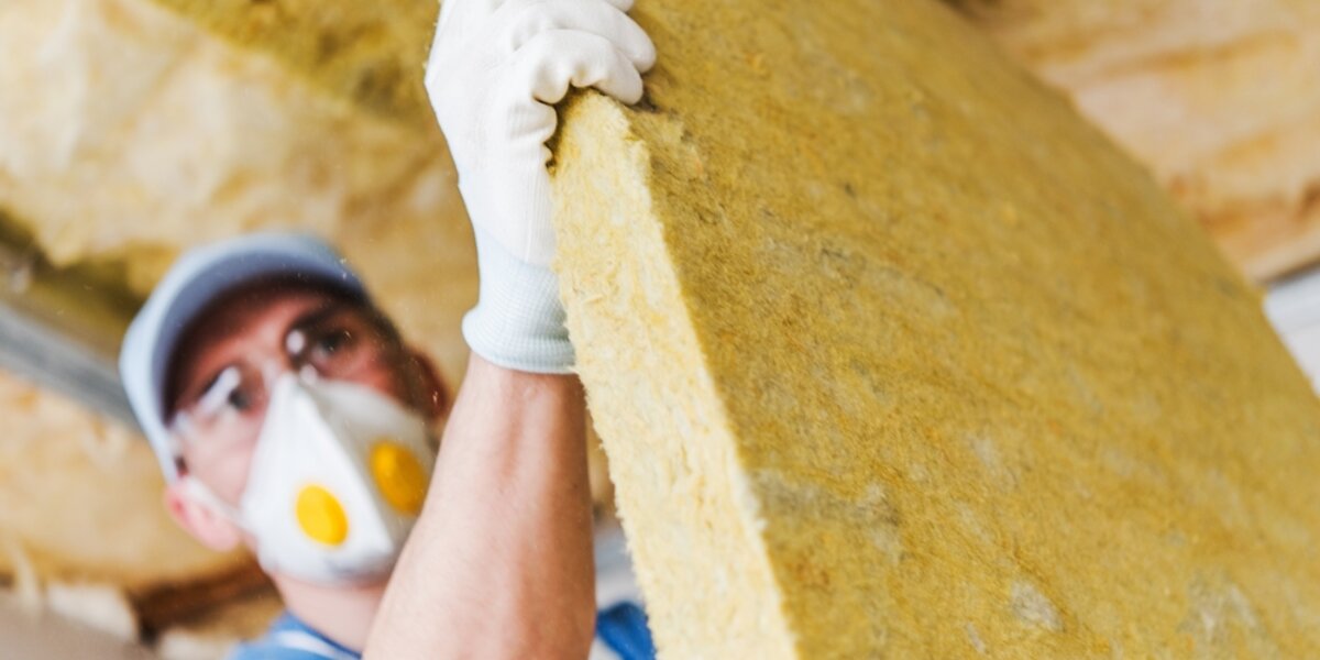 Man installing insulation. 